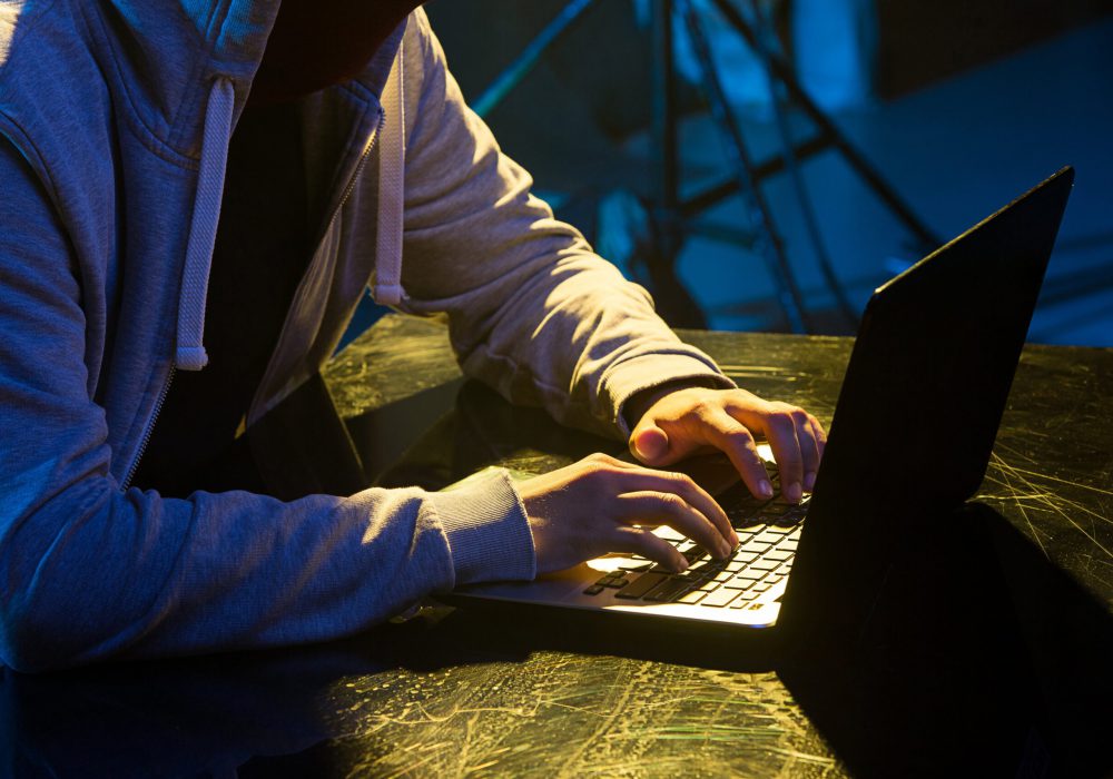 hooded-computer-hacker-stealing-information-with-l-PTVCC26-min